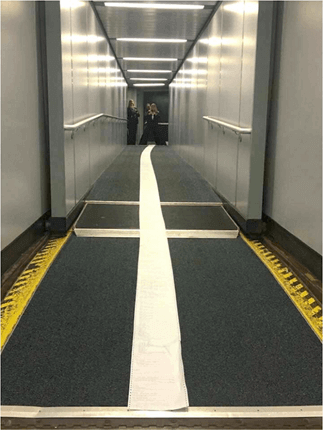 Long paper NOTAM printout rolled out across an airport jet bridge, highlighting the excessive length of pre-flight briefing documents.