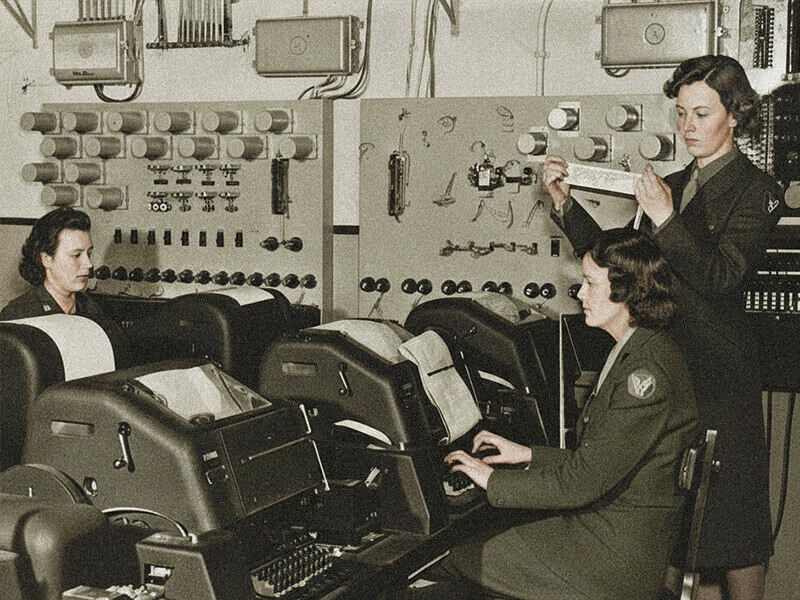 Banner image showing women in uniform operating vintage teletype machines in an early aviation communication centre, illustrating NOTAM evolution.
