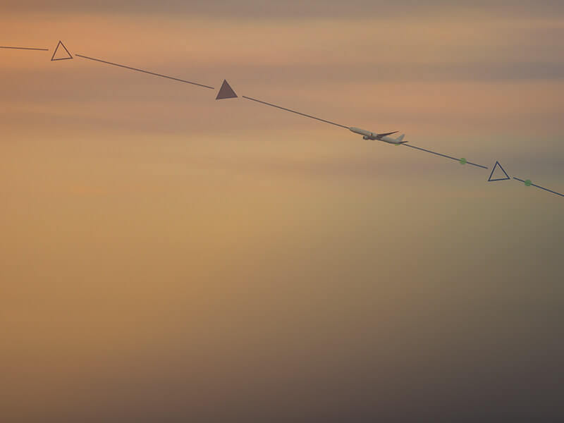 A plane flying through the sky, representing flexibility in flight planning and operations, with graphical symbols on the path.