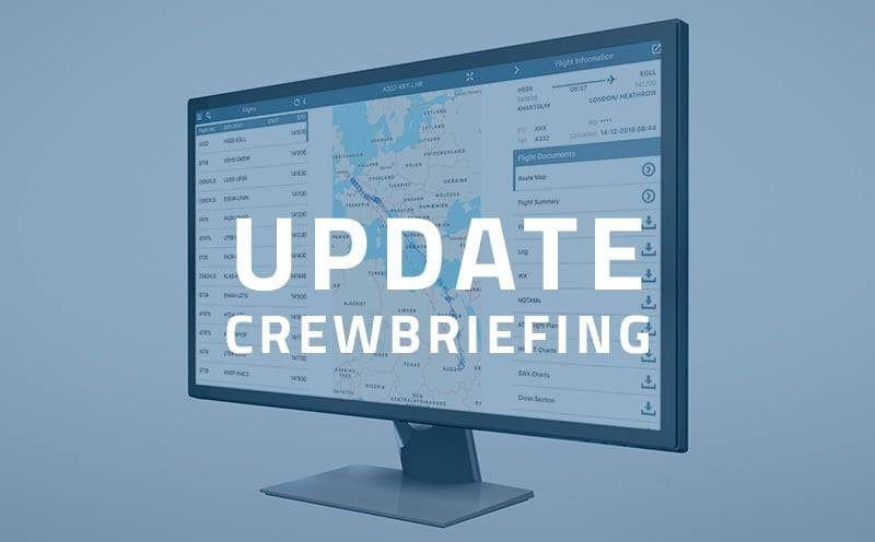 Desktop monitor displaying the CrewBriefing interface with a text overlay that reads "CrewBriefing Update," featuring flight planning details and map visuals.