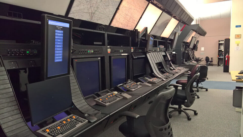 
Air traffic control operations room with radar displays and workstations, highlighting the controller’s role in managing traffic and enabling CCO/CDO procedures.